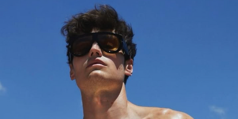 German content creator Moritz Hau was seen wearing black Tom Ford Bronson TF1044 01E sunglasses with yellow lenses at Tom Ford Beauty's Soleil Blanc perfume launch event in Greece, July 2025.