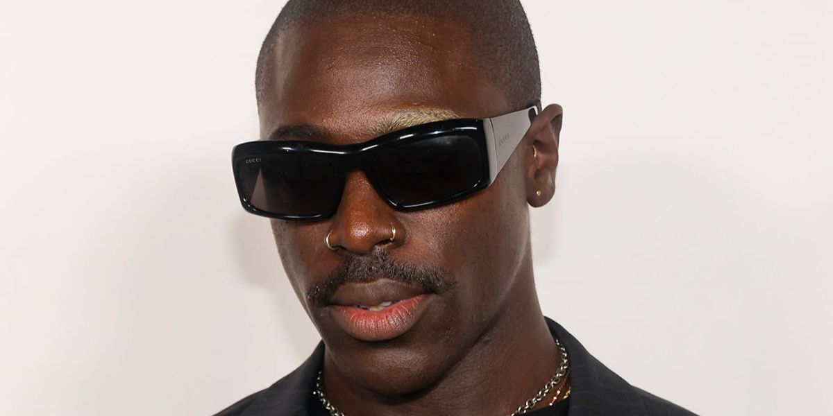 Actor and singer Moses Sumney was seen wearing black Gucci GG2273S 001 wraparound sunglasses at the Los Angeles premiere of "The Drama", March 2026.