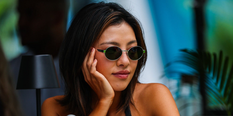 Professional golfer Muni He was seen wearing silver Saint Laurent Sun SL 692 002 oval sunglasses with grey lenses at the F1 Miami Grand Prix 2025.