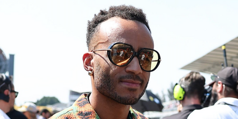 Actor and comedian Munya Chawawa was seen wearing black Bottega Veneta BV1436S 001 Drop Sunglasses at the F1 Grand Prix of Mexico 2025.
