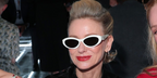 Naomi Watts was seen wearing white Prada PR 26ZS 17K08Z cat-eye sunglasses at the Prada Spring/Summer 2026 fashion show during Milan Fashion Week.