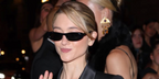 Natalia Dyer wore black Saint Laurent SL 557 SHADE Plump 001 sunglasses at the Saint Laurent Spring Summer 2027 show during Paris Fashion Week.