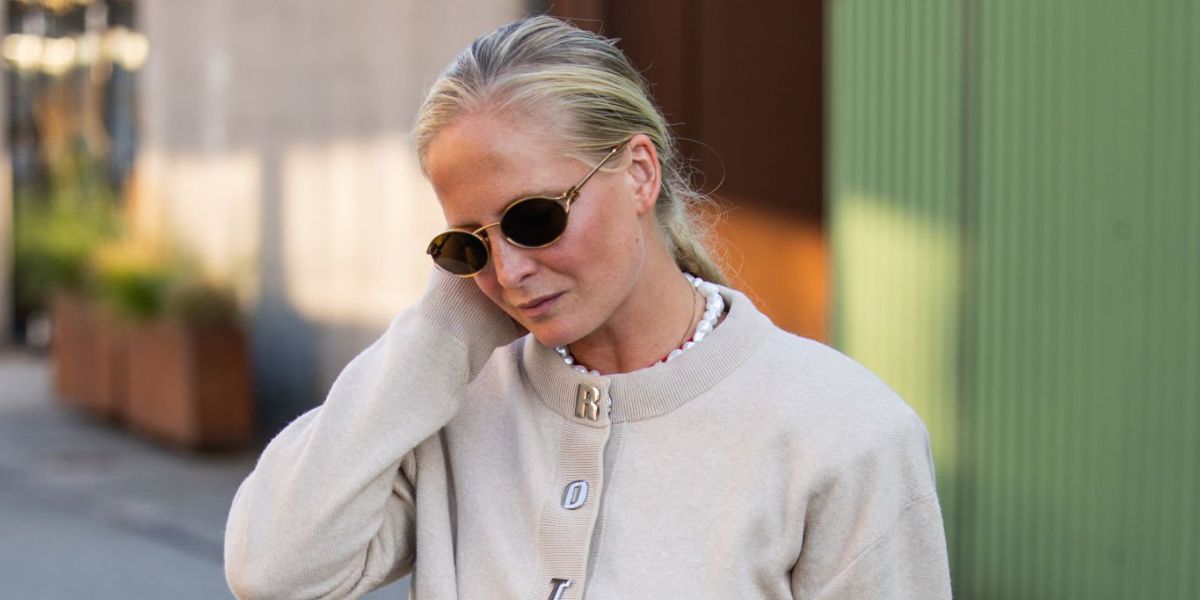 Norwegian fashion journalist Nathalie Helgerud of Elle Norge was seen wearing gold Miu Miu MU 52YS 7OE01T round sunglasses at the Copenhagen Fashion Week season Spring/Summer 2025