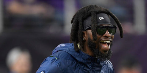 American football player Neiko Thorpe of the Seattle Sehawks was seen wearing black Saint Laurent Sun SL1 Black/Grey Mirrored 001 sunglasses before a game against the Minnesota Vikings in August 2018.