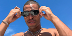 Nicholas Duvernay was seen wearing the iconic black Prada PR 17WS 1AB5S0 Symbole Sunglasses on the set of The White Lotus season 3 in Thailand