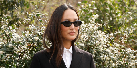 Australian designer Nicole Warne was seen wearing black Prada PR 26ZS 16K08Z cat eye sunglasses at the Hermes Fall/Winter 2026 fashion show during Paris Fashion Week.