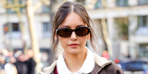 Celebrity actress Nina Dobrev was seen wearing new Miu Miu MU B09S 14L20V round sunglasses in tortoiseshell with brown lenses at the Miu Miu Fall/Winter 2026 show during Paris Fashion Week.