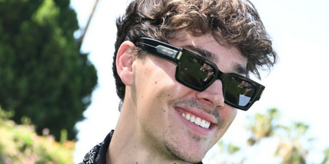 Noah Beck wearing black Saint Laurent sunglasses at Coachella Festival 2024