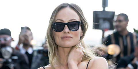 Olivia Wilde was seen wearing black Ray-Ban Wayfarer Reverse RB R0502S 6677/72 sunglasses with blue lenses at the Michael Kors Spring/Summer 2025 fashion show during New York Fashion Week.