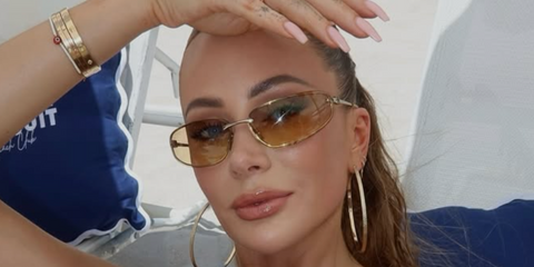 Olivia Attwood wears Miu Miu MU A50S 5AK7R1 sunglasses at Miami Swim Week 2025