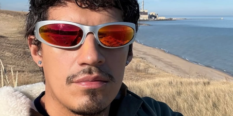 Omar Apollo was seen wearing grey silver Balenciaga BB0290S 004 wraparound sunglasses with red mirror lenses in an Instagram selfie