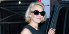 Pamela Anderson was seen wearing black Garrett Leight Mr. Leight Portia S ML2053 BK-GM/BLUOPL Limited Edition oval sunglasses with blue lenses in New York City, May 2025. Shop online now on Pretavoir