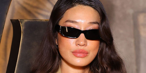 DJ Peggy Gou was seen wearing black Saint Laurent Sun SL M152/F 001 Asian Fit sunglasses at the Saint Laurent Fall/Winter 2026 fashion show during Paris Fashion Week.