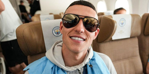 Phil Foden was seen wearing black Ray-Ban RB 4320CH 601/J0 Polarised sunglasses with blue and gold lenses on his way back to the UK from Istanbul with the Manchester City team after 2023 Champions League victory