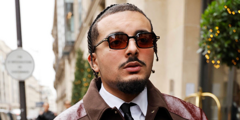 French rapper RK (Ryad Kartoum) was seen wearing black Cartier CT0539S 003 sunglasses with brown lenses during Paris Men's Fashion Week Fall/Winter 2026