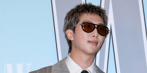 South Korean singer RM of K-Pop group BTS was seen wearing black Bottega Veneta BV1418S 001 sunglasses with yellow lenses at the W Magazine Korea Breast Cancer Awareness Campaign "Love Your W" photo call, October 2025. Shop online now on Pretavoir