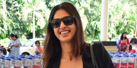Bollywood actress Radhika Apte was seen wearing black rubber Ray-Ban Justin 4165 601/8G sunglasses at an airport