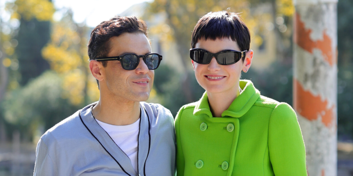 Rami Malek, pictured with girlfriend Emma Corrin, was seen wearing black Prada PR A16S 16K04D sunglasses with blue green Polarised lenses at the 2024 Venice Film Festival