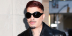 Rauw Alejandro wore black Alexander McQueen AM0592S 001 Kate Round sunglasses at an Audermars Piguet event during New York Fashion Week Spring/Summer 2027