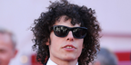 Digital creator Reece Feldman, widely known as Guy With A Movie Camera, was seen wearing black Saint Laurent Sun SL 815 Romy 001 sunglasses at the Karma screening during Cannes Film Festival 2026.