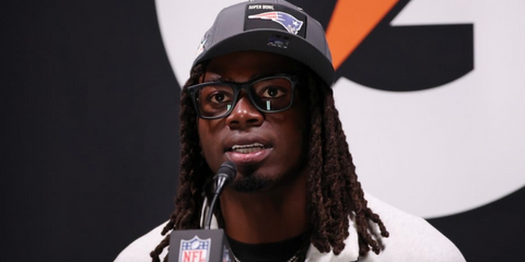 American football player Rhamondre Stevenson of New England Patriots was seen wearing black Ray-Ban Meta Wayfarer Gen 2 RW4012 601S/SB Smart Glasses at a press conference ahead of the Super Bowl LX 2026.
