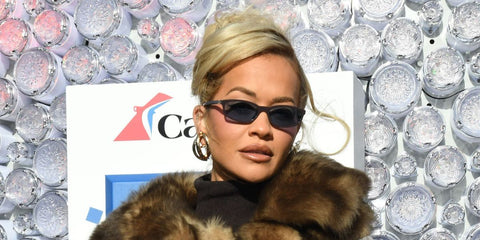 Rita Ora was seen wearing brown Miu Miu MU A06S 22C60O sunglasses with blue lenses at the "Dick Clark's New Year's Rockin' Eve With Ryan Seacrest 2026" press junket in New York City, December 2025.