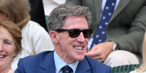 Welsh actor, comedian, and presenter Rob Brydon was seen wearing black Ray-Ban New Wayfarer 2132 901/58 Polarised sunglasses at the Wimbledon Tennis Championships 2025. Shop online now on Pretavoir