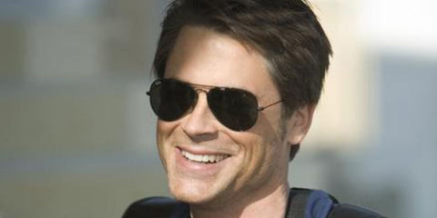 Young Rob Lowe was seen wearing Ray-Ban Aviator RB 3025 L2823 Black sunglasses with Green lenses