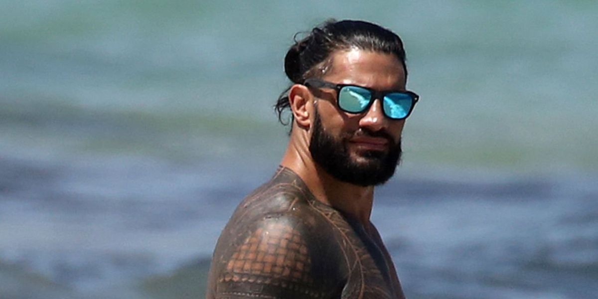 Joe Anoa'i also known as Roman Reigns was seen wearing black Ray-Ban Justin 4165 622/55 sunglasses with blue mirrored lenses in Miami, Florida