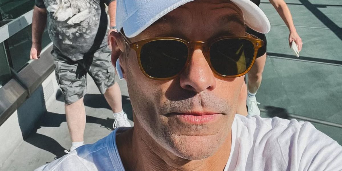 Ryan Seacrest was seen wearing transparent amber Oliver Peoples Finley Esq. Sun U OV5298SU 1578/W5 round sunglasses in his Instagram post, August 2024