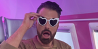 Rylan Clark was seen wearing ivory white heart-shaped Saint Laurent Sun SL 181 LouLou 003 sunglasses in his Instagram post