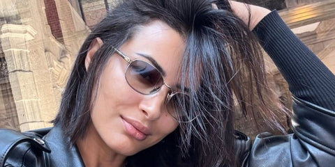 Tunisian model and actress Rym Saidi was seen wearing silver Prada PR B53S 1BC80K sunglasses with brown gradient lenses in her Instagram post, April 2025.