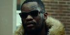 Rapper Santan Dave was seen wearing black and beige Ray-Ban New Wayfarer 2132 875 Color Mix sunglasses in 2019 Netflix show Top Boy.