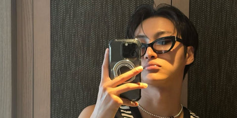 South Korean singer Seonghwa of K-Pop group ATEEZ was seen wearing black Saint Laurent Sun SL M115 002 cat eye sunglasses with grey gradient lenses in his Instagram post, September 2025.