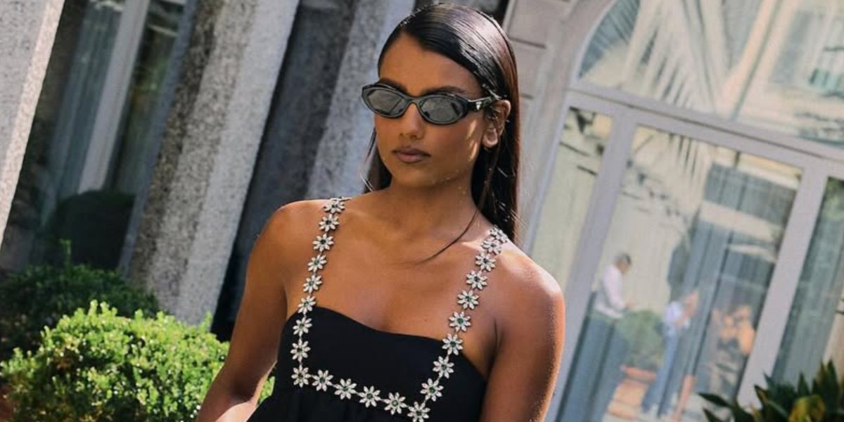 Simone Ashley was seen wearing black Prada PR 26ZS 16K08Z round oval sunglasses to attend the Prada Spring/Summer 2025 fashion show during Milan Fashion Week
