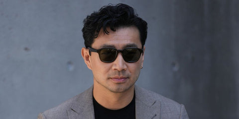 Actor Simu Liu was seen wearing black Giorgio Armani AR8206 6060/1 sunglasses with grey lenses at the Giorgio Armani Menswear Spring/Summer 2026 fashion show during Milan Men's Fashion Week. Shop online now on Pretavoir