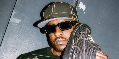 Rapper Skepta was seen wearing black Prada PR 06YS 09Q5S0 sunglasses in the Kickers & Maison London collaboration shoot, shared through Huxley's Instagram post in June 2025.