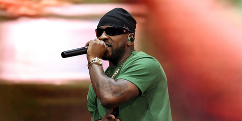 Rapper Skepta was seen wearing black Prada PR A19S 1AB5S0 wraparound sunglasses at the Wireless Festival 2025 in London.