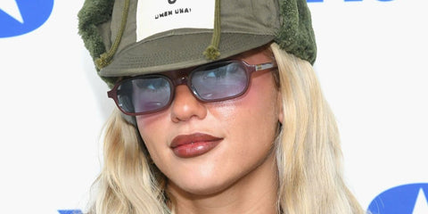 Singer-songwriter Skye Newman was seen wearing brown Miu Miu MU 11ZS 22C60O rectangular sunglasses with blue lenses as she visited SiriusXM Studios in New York City, February 2026.