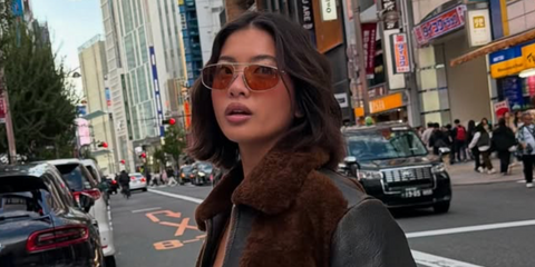 Digital creator Stephanie Hui was seen wearing gold Prada PR C51S 5AK70G sunglasses in Tokyo, shared through her Instagram post in November 2025.