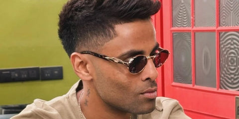 Indian cricketer and captain of India National Cricket Team Suryakumar Yadav was seen wearing gold and black Prada PR 65ZS ZVN09T round sunglasses.