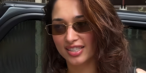 Bollywood actress Tamannaah Bhatia was seen wearing gold Prada PR A60S 5AK70G rectangular sunglasses with olive lenses in a fan social media post