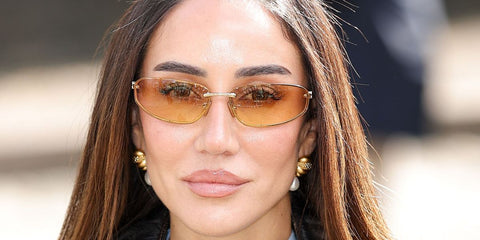 Tamara Kalinic was seen wearing gold Miu Miu MU A50S 5AK7R1 sunglasses with yellow gradient lenses at the Miu Miu Fall/Winter 2026 fashion show during Paris Fashion Week.