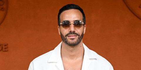 French actor Tarek Boudali was seen wearing gold Bottega Veneta BV1379S 003 rimless round sunglasses with brown lenses at the 2025 French Open. Shop online now on Pretavoir