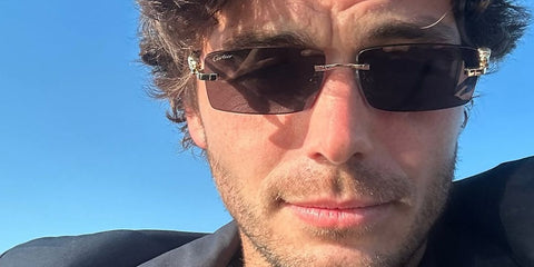 Tennis player Taylor Fritz was seen wearing gold Cartier Panthere CT0505S 001 rimless sunglasses with grey lenses in his Instagram post, April 2026.