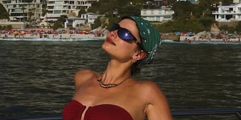 Taylor Hill was seen wearing black Miu Miu MU A02S 19Y10K shield sunglasses with blue mirror lenses in her Instagram post, January 2026.