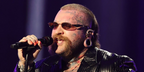 Teddy Swims wore gold Prada PR D51S 5AK20I sunglasses with purple brown lenses onstage during MTV Video Music Awards 2026.