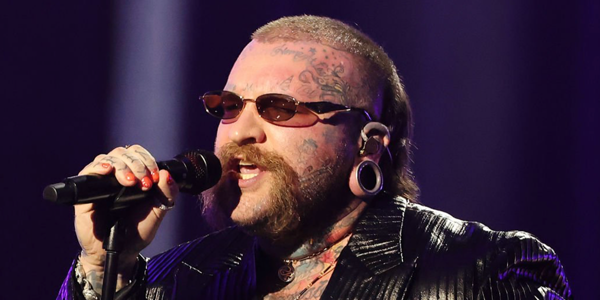 Teddy Swims wore gold Prada PR D51S 5AK20I sunglasses with purple brown lenses onstage during MTV Video Music Awards 2026.