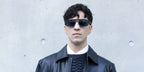 Italian singer Tedua was seen wearing matte black Emporio Armani EA4240U 5017/87 sunglasses with blue lenses at the Emporio Armani FallWinter 2026 fashion show during Milan Fashion Week.