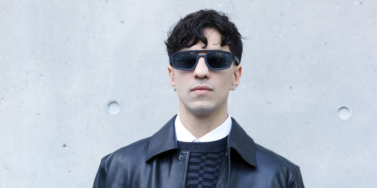 Italian singer Tedua was seen wearing matte black Emporio Armani EA4240U 5017/87 sunglasses with blue lenses at the Emporio Armani FallWinter 2026 fashion show during Milan Fashion Week.